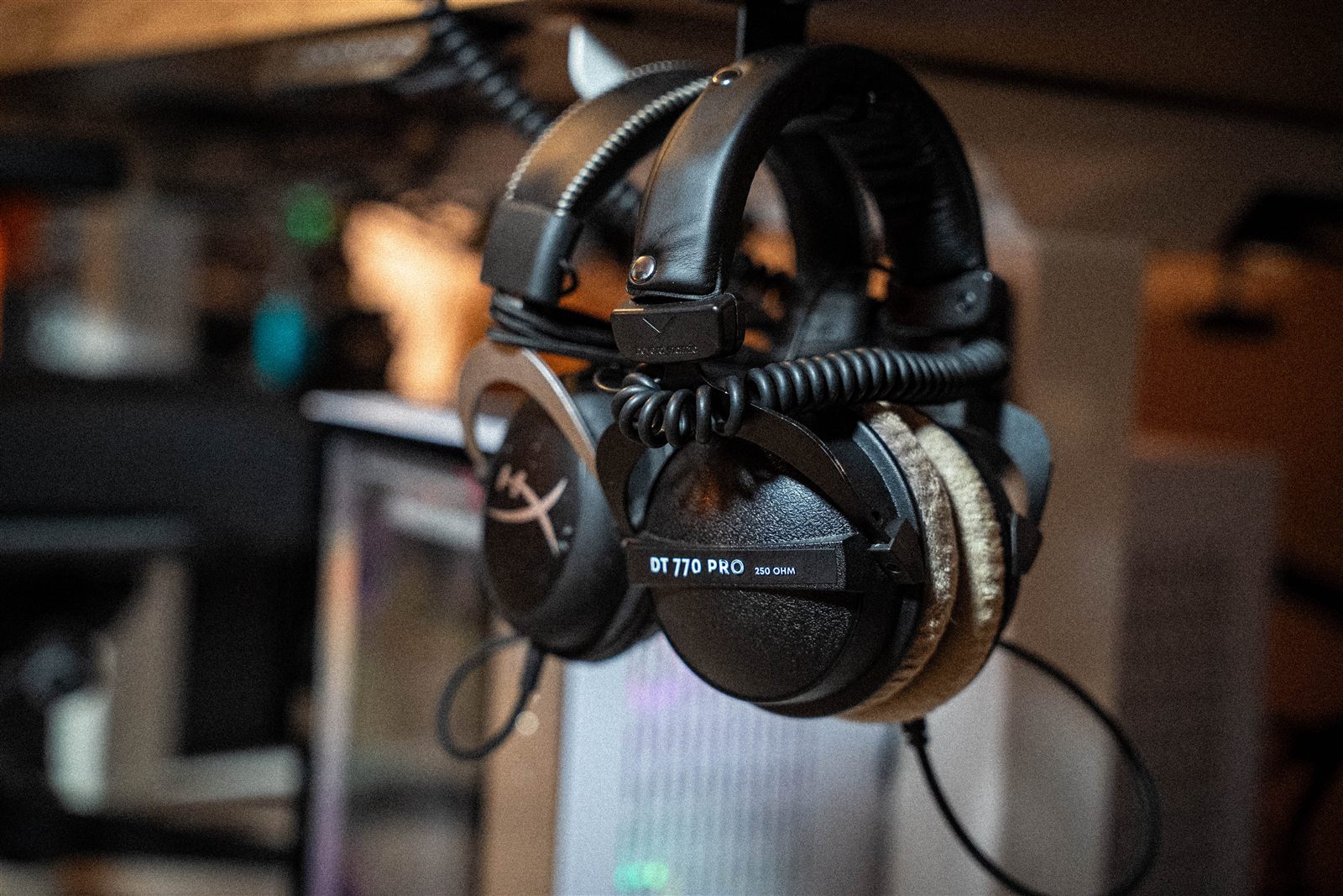 Headphones hanging under the desk